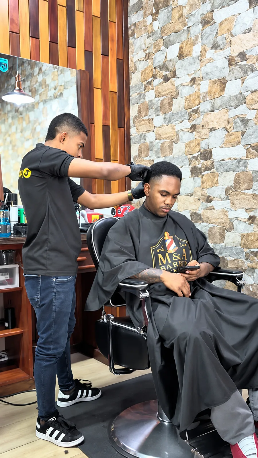 Barbero de M&A trabajando en un corte dentro del local